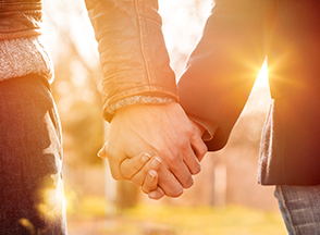 Two people holding hands