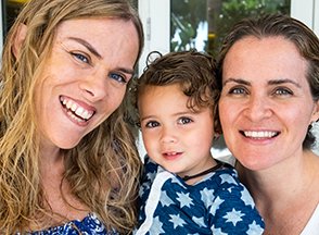 A baby between two women.