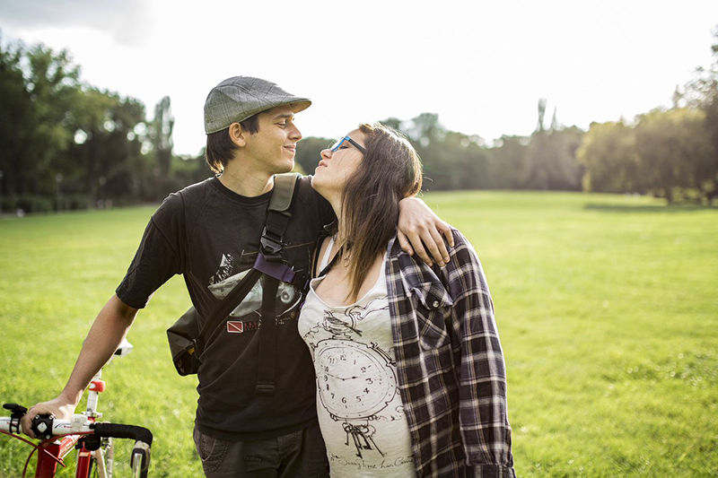 Man and woman looking into each others eys with arms around each other.