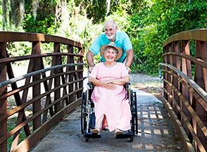 senior in wheelchair being pushed