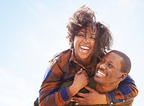 Woman piggybacking on back of man.