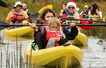 Group of participants in kayaks at a guided paddle in a natural area