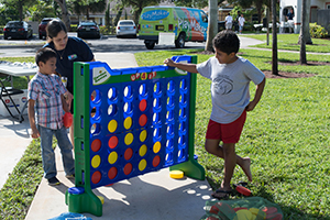 Three youths outside playing a game.