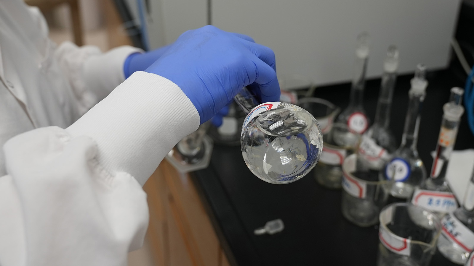 hands holding test tube with water in it in a sterile laboratory